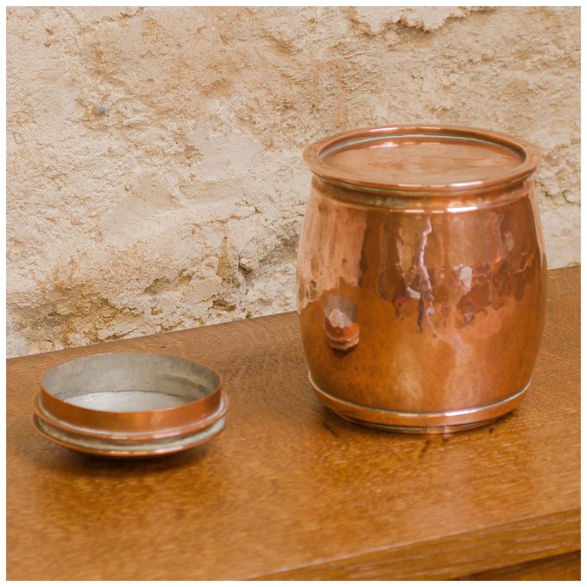 An Arts & Crafts Lakes School hand beaten copper jar by Fanny Carter