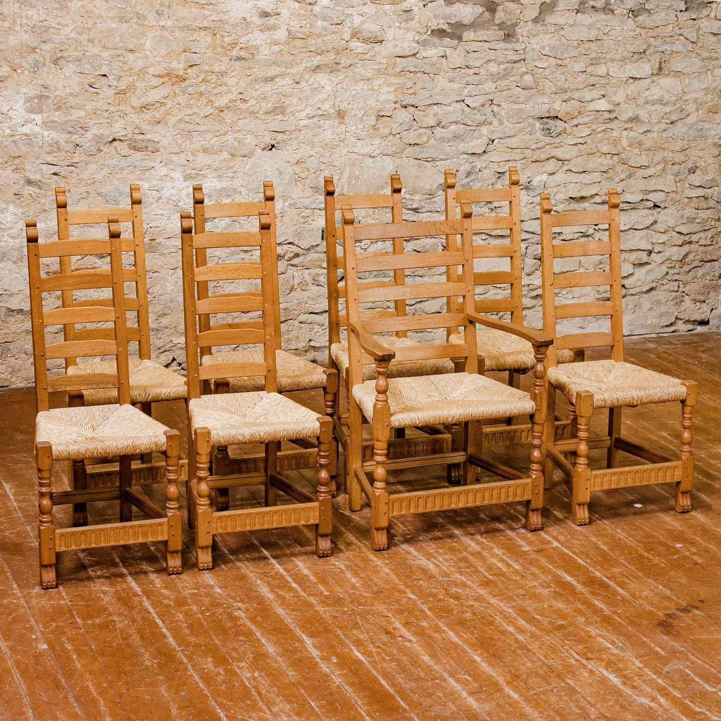 A set of 8 Rupert Griffiths Arts & Crafts English Oak Rush Seated Dining Chairs